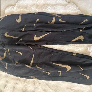 Nike Black Sweatpants with Gold Swoosh Pattern